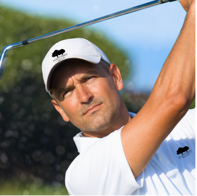 Golfer wearing white Tilgate Forest Golf Club cap with club logo during swing on sunny course.